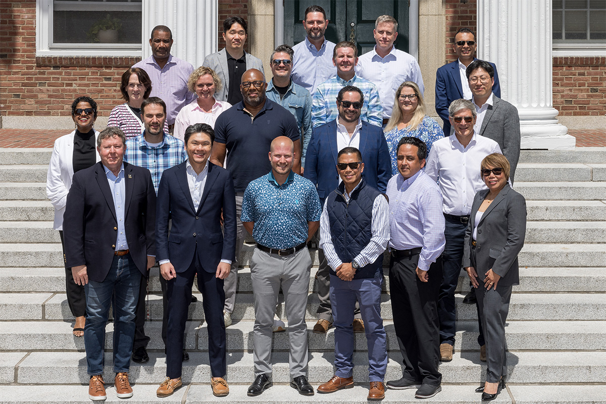 Alumni participants of the 2024 Tuck Advanced Management Program pictured on the steps of Tuck Hall